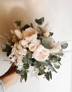 a person holding a bouquet of flowers in their hand