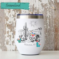 a white wine tumbler with a cactus scene on the side and personalized lettering