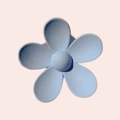 an image of a blue flower that is in the middle of the frame with light pink background