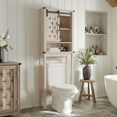 a white toilet sitting next to a wooden cabinet