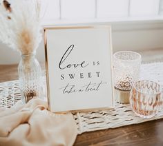 a sign that reads, sign our guestbook next to two glasses on a table