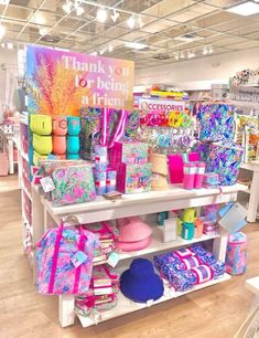 a display in a store filled with lots of colorful bags and gifts on top of shelves