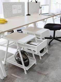 an office desk with two chairs and a banana on the table in front of it