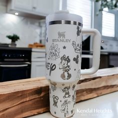 a mickey mouse travel mug sitting on top of a counter