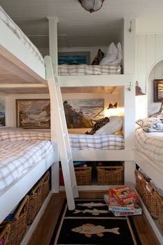 two bunk beds in a room with baskets on the floor