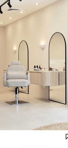 a white chair sitting in front of a mirror