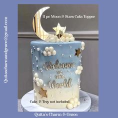 a blue and white cake with the words welcome to the world on it's side