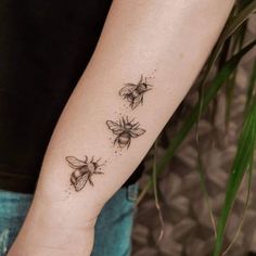 three bees tattoo on the left arm