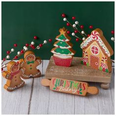 three gingerbread christmas cookies on a wooden board and one is decorated with icing