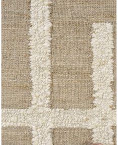 a beige and white rug with squares on it