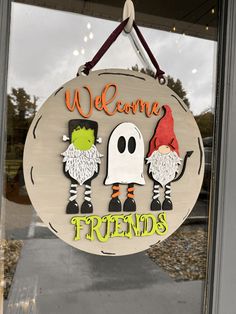 a sign that says welcome to friends with two gnomes and a ghost on it