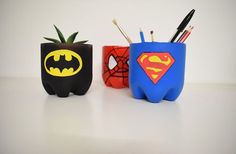 three different colored pencil holders with batman, spiderman and pineapple