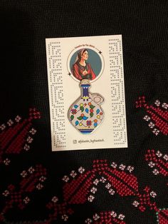 a card with an image of a woman in a bottle on it next to some beads