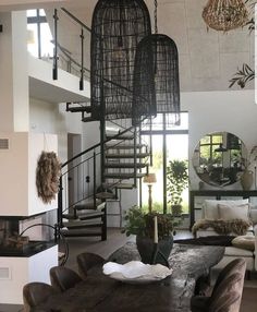 a living room filled with furniture and a spiral staircase