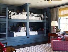 a bedroom with bunk beds and blue walls