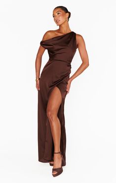 Chic and sophisticated in the Jodie Dress. An elegant asymmetrical silhouette crafted in luxe satin with a draped neckline and sultry side slit. Styled with dainty heels and minimal jewelry make the perfect event attire. Brown Prom Dress, Dainty Heels, Event Attire, Homecoming Dresses Corset, Midi Dress Wedding Guest, Bronze Dress, Draped Neckline, Asymmetric Neckline, Maxi Dress Sale