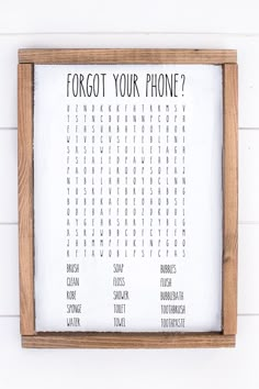 a wooden framed sign with the words forgot your phone written in black and white on it