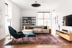 a living room filled with furniture and a flat screen tv