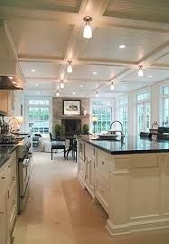 a large kitchen with white cabinets and black counter tops