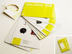 yellow and white business cards with tags attached to them