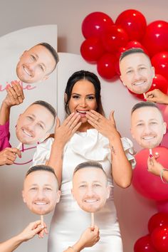 a group of people posing for a photo with their faces cut out and balloons in the background