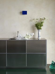 a vase filled with flowers sitting on top of a counter