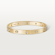 Cartier - LOVE bracelet, 10 diamonds - Bracelet Gold/Gold - LOVE bracelet, yellow gold 750/1000, set with 10 brilliant-cut diamonds totaling 0.96 carats. Comes with a screwdriver. Width: 6.1 mm. Created in New York in 1969, the LOVE bracelet is an icon of jewelry design: a close fitting, oval bracelet composed of two rigid arcs which is worn on the wrist and removed using a specific screwdriver. The closure is designed with two functional screws placed on either side of the bracelet: you will ne Bracelet Dior, Bracelet Cartier, Cartier Bracelet, Bracelet Love, Love Bracelet, Cartier Love, Diamonds And Gold, Bracelet Collection, Cartier Love Bracelet