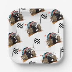 a square plate with a monster truck on it's side and checkered flag in the background