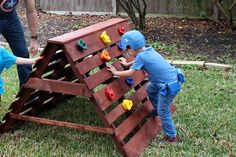 two young children playing with wooden blocks in the yard