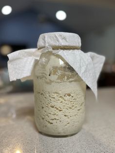 a glass jar with some white paper on it