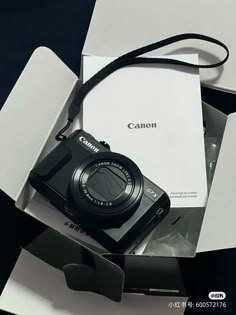 a camera sitting inside of a box on top of a table