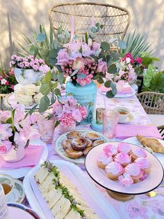 a table topped with lots of food and flowers