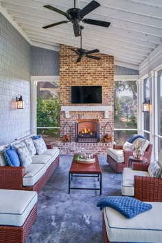 an outdoor living room with couches and a fireplace