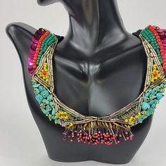 Branded by Seyyah, this colorful "social necklace" is a perfect staple pieces to elevate your everyday look. Crochet based embroidery statement necklace Adorned with seed and bugle beads, sequins, and semiprecious gemstones Two snaps to adjust the length Black crochet base length: 19-21", weight 1.6 oz About the brand: Seyyah is a brand that offers bold, unique, and colorful accessories inspired by travels around the world... and most importantly help to empower women. The brand "provides fair w Artisan Multicolor Beaded Necklaces With Fringe, Artisan Multicolor Beaded Necklace With Fringe, Party Embellished Beaded Necklaces With Round Beads, Festival Multicolor Beaded Bib Necklace, Bohemian Embellished Necklaces For Party, Bohemian Embellished Necklace For Party, Handmade Multicolor Beaded Necklaces For Party, Embellished Multicolor Necklace For Party, Embellished Multicolor Party Necklaces