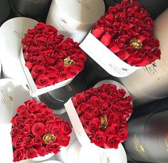 three heart shaped boxes filled with red roses