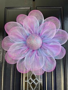 a purple flower is hanging on the front door