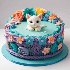 a cake decorated with flowers and a cat figurine