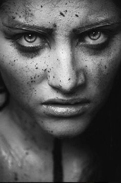 a black and white photo of a woman with freckles on her face