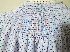 a dress with blue and white polka dots on it