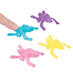 a finger is pointing at three small plastic animals