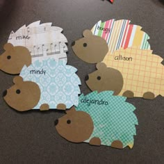 four cut out animals sitting on top of a table next to each other with name tags