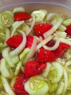 a bowl filled with sliced up vegetables and sauce