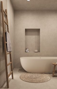 a white bath tub sitting next to a wooden ladder in a bathroom with beige walls