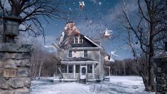 an old house in the middle of winter with birds flying over it and snow on the ground