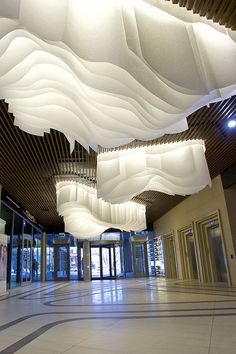 a large room with many lights hanging from the ceiling