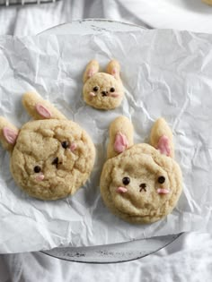 three cookies with bunny ears on them sitting on wax paper