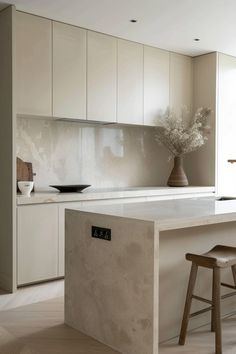 a kitchen with an island and stools in it