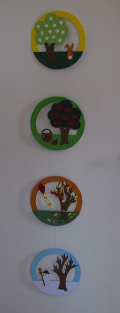 four circular wall hangings with trees and animals on them