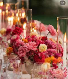 a table topped with lots of flowers and candles