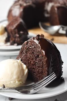 a piece of chocolate cake with ice cream on a plate next to a half eaten bundt cake